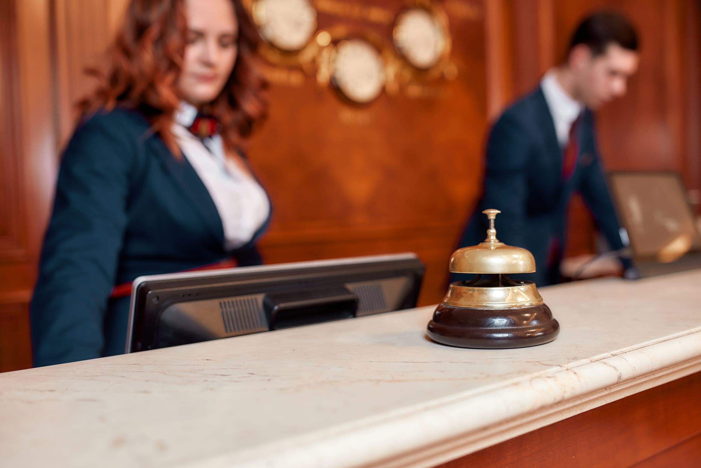 Reception desk with a brass service bell, indicating front-of-house operations