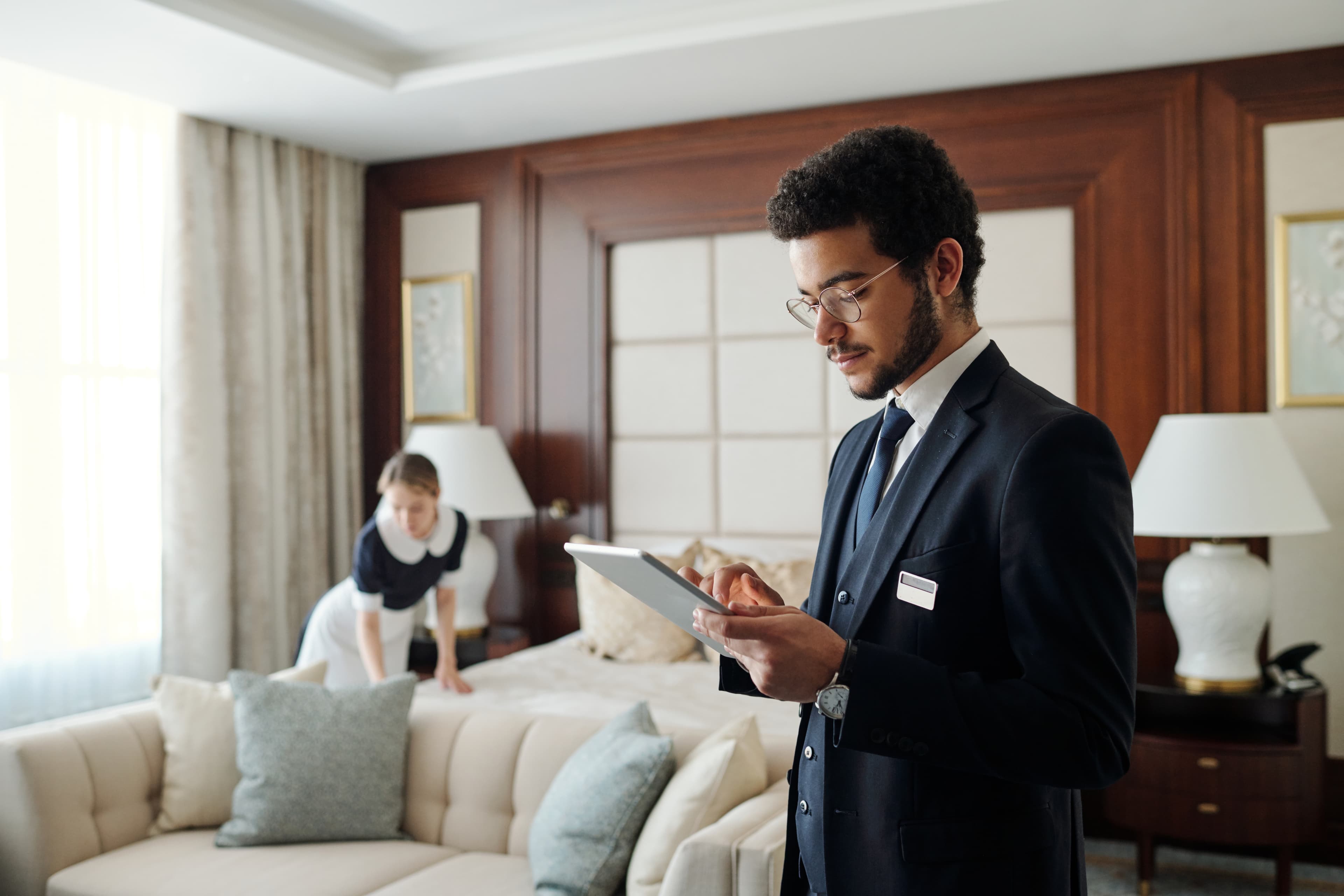 Hotel manager reviewing the day on a tablet